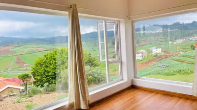 a room with two large windows with a view at Away From Home - 3 - Rooms In Ooty, Home Stay Ooty in Ooty