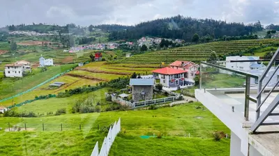 an aerial view of a village on a hill at Away From Home - 3 - Rooms In Ooty, Home Stay Ooty in Ooty