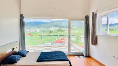 a bedroom with a bed and a large window at Away From Home - 3 - Rooms In Ooty, Home Stay Ooty in Ooty