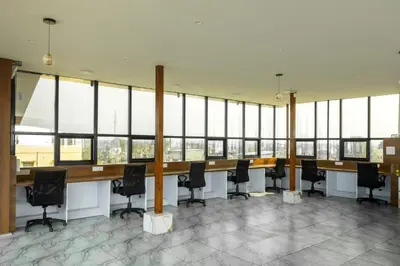 a conference room with a long table and black chairs at Bharath Pods in Coimbatore