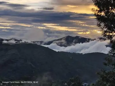 a view of a mountain with clouds in the sky at May Fair Vista Luxury Villa - Huge Lawn - Scenic Views - Free Parking in Kotagiri