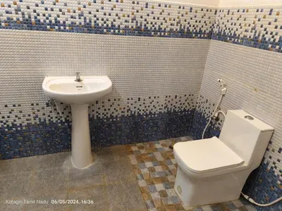 a bathroom with a toilet and a sink at May Fair Vista Luxury Villa - Huge Lawn - Scenic Views - Free Parking in Kotagiri