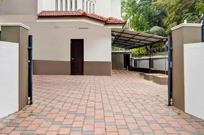 a building with a brick driveway in front of a door at Super Hotel O West Hill near Mietra Hospital in Calicut