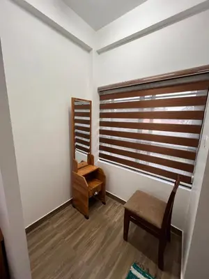 a dressing room with a chair and a mirror at Ashtapadi Inn in Guruvāyūr