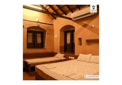 a bedroom with two beds and a air conditioner at Down to Earth Farmstay by LAKSEM in Anaimalai
