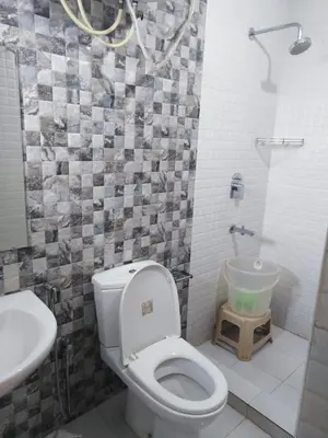a bathroom with a toilet and a sink at Ooty Blue Mountain Villa Thalayathimund in Ooty