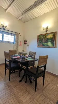 a dining room with a table and chairs at Yellow House Kotagiri in Kotagiri