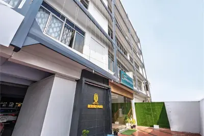 a building with a door with a sign on it at Hotel Beverly Plaza Kozhikode in Kozhikode