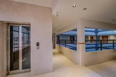 a view of the pool from the balcony of a building at Hotel Beverly Plaza Kozhikode in Kozhikode