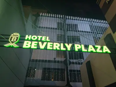 a sign that says hotel beverly plaza in a building at Hotel Beverly Plaza Kozhikode in Kozhikode