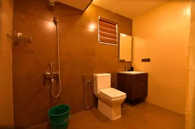a bathroom with a toilet and a shower at Garuda Luxury Bungalow in Trichūr