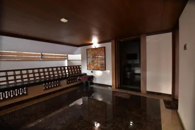 a lobby of a building with a marble floor at Garuda Luxury Bungalow in Trichūr