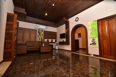 a living room with a couch and a lobby at Garuda Luxury Bungalow in Trichūr