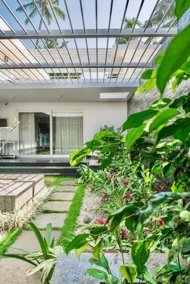 a garden with plants and a glass ceiling at Resort Type Three Bed Room Villa in Trichūr