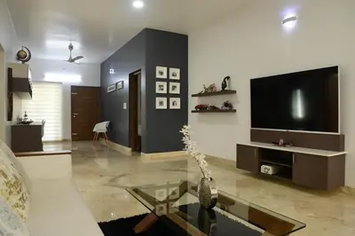 a living room with a couch and a tv at Resort Type Three Bed Room Villa in Trichūr
