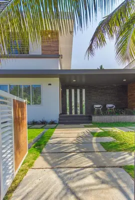 a house with a palm tree in front of it at Resort Type Three Bed Room Villa in Trichūr