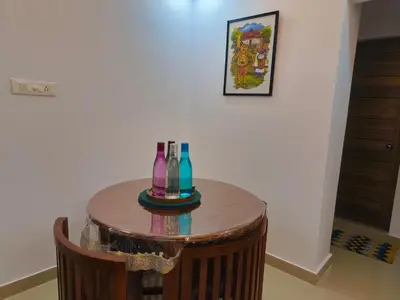 a table with bottles on it in a room at Posh 1 BHK Apt with Temple View in Guruvayur C1301 in Guruvāyūr