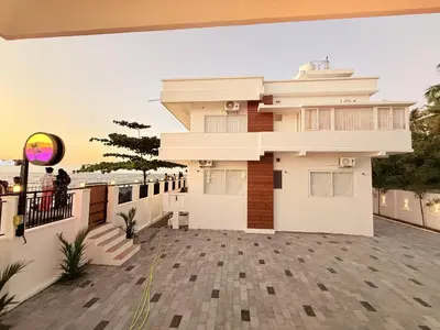 a view of a house from the balcony at Golden Sands Cherai in Cherai Beach