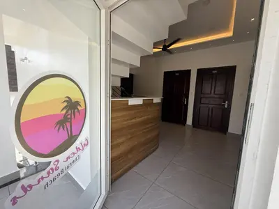 a view of a kitchen with a palm tree sign on the door at Golden Sands Cherai in Cherai Beach