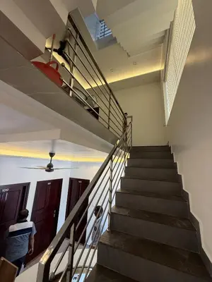 a person walking down a staircase in a building at Golden Sands Cherai in Cherai Beach