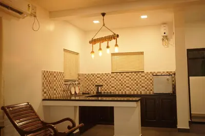 a kitchen with a sink and a counter top at Golden Sands Cherai in Cherai Beach