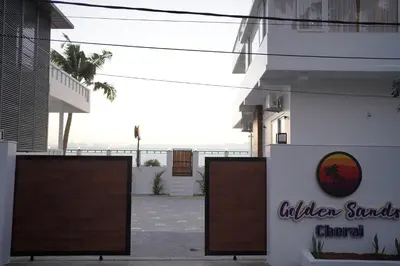 a sign in front of a building at Golden Sands Cherai in Cherai Beach