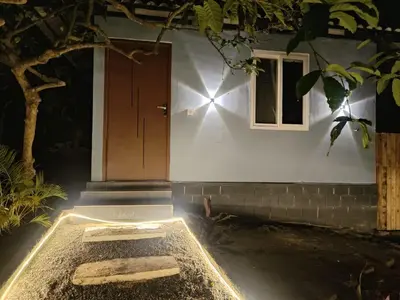 a small house with a door and a window at The Cozy Clouds Hill Stay in Napoklu