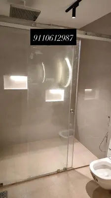 a glass door in a bathroom with a toilet at The Cozy Clouds Hill Stay in Napoklu