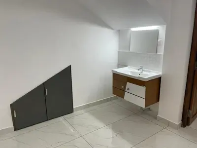 a bathroom with a sink and a mirror at RoyalGiri Apartment near Rajagiri Hospital in Alwaye