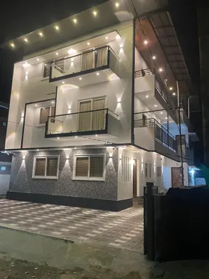 a large white building with a balcony on top of it at RoyalGiri Apartment near Rajagiri Hospital in Alwaye