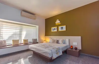 a bedroom with a large bed and a window at Resort Type Three Bed Room Villa in Trichūr
