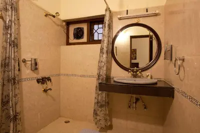 a bathroom with a sink and a mirror at Away From Home - 2 - Rooms In Ooty, Home Stay Ooty in Ooty