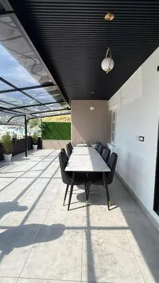 a table and chairs sitting on a patio at Leafy Mist Villa in Munnar