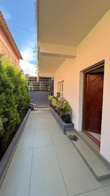 a hallway of a house with a door and plants at Leafy Mist Villa in Munnar
