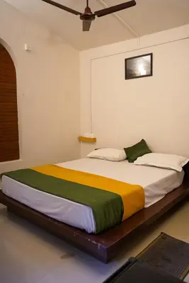 a bedroom with a large bed in a room at Misty Hills Cabin in Wayanad