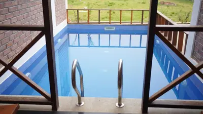a view of a swimming pool from a balcony at Preserve Ooty in Ooty