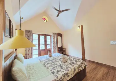 a bedroom with a bed and a ceiling fan at Preserve Ooty in Ooty