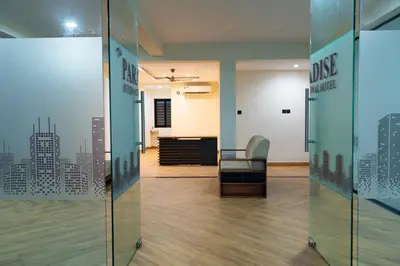 an office with glass doors with a view of a city at The Paradise International Hotel in Coimbatore