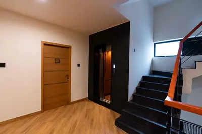 a room with a staircase and a door at The Paradise International Hotel in Coimbatore