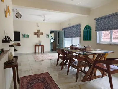 a dining room with a table and chairs at 7 Elysee Homestay - Safire - Premium 3BHK Family Flat in Trichūr