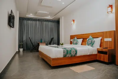 a bedroom with a large bed and a television at Saj Heritage in Kalpetta