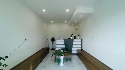 a room with white walls and a table and chairs at Saj Heritage in Kalpetta