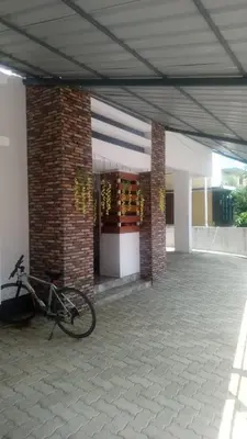 a bike parked in front of a building at Stay Castle in Guruvāyūr