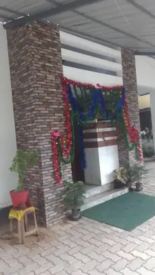 a house with christmas decorations on the side of it at Stay Castle in Guruvāyūr