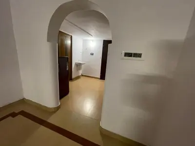 an empty hallway with an archway in a building at Rock Hill - Pachakkad Home Stay in Athirappally