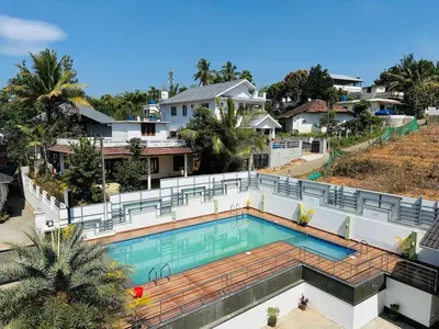 an aerial view of a house with a swimming pool at Crystal Winter Arcade wayanad in Wayanad