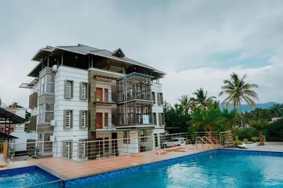 a large house with a swimming pool in front of it at Crystal Winter Arcade wayanad in Wayanad