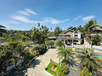 an aerial view of a house with palm trees at Crystal Winter Arcade wayanad in Wayanad