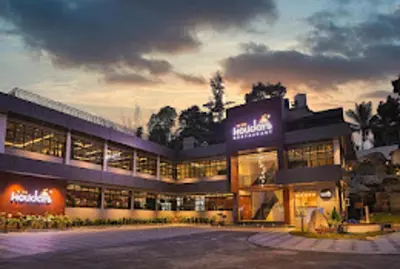 a large building with a lot of windows at Holidays Garden Resort in Kalpetta