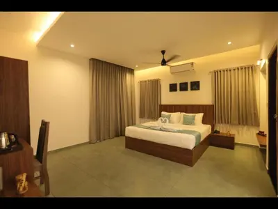 a bedroom with a bed in a room at Holidays Garden Resort in Kalpetta